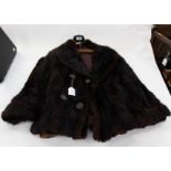 A short fur jacket in black mink, double breasted large buttons x four,