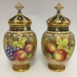 A pair of Royal Worcester fruit painted pot pourri vases and covers, ref: 2048,