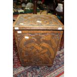 An early 20th Century oak carved coal box, carved with Celtic Zoomorphic design,