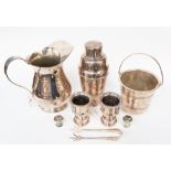 A collection of silver plated items to include a cocktail shaker, water jug, ice bucket and tongs,