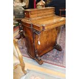 A mid Victorian walnut Davenport, decorated throughout in walnut quarter veneers,