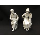 Pair of continental blanc de chine figures of seated tennis players (one restored)