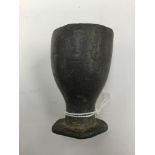 A small pewter cup 7cm in height, 4.5cm in width. Some circular decoration around the rim.