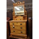 An Edwardian Art Nouveau dressing chest, with a mirrored back,