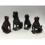 A set of four early 18th century Staffordshire treacle glazed dogs, poodle form,