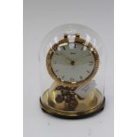 A Kundo mechanical anniversary clock glass dome