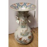 A twin handled Chinese vase having floral and foliate pattern and deep flared rim,