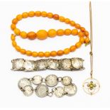 A 9ct openwork peridot and pearl pendant, two coin bracelets, along with an amber type necklace,