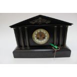 A large Victorian slate clock with corinthain style pillars to the front with key