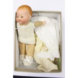Armand Marseille: A German bisque head baby doll, cloth body, incised to neck, ' AM Germany',