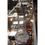 An Edwardian silver plated cut glass claret jug, the silver plated mount with swag decoration,