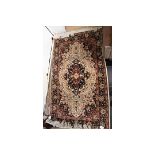 A small hand knotted woollen rug, with a cream ground and blue border,