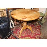 A circular topped single pedestal dining table,