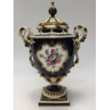 A large Royal Worcester molded and elaborate twin handled pedestal vase and cover,