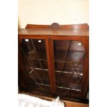 An Art Deco oak two door glazed display cabinet