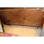 A George III mahogany drop-leaf dining table, with square sectioned leaves,