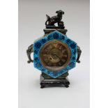 Majolica Continental mantle clock with brass dial and Roman numerals,