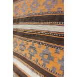Two 1970's hand knotted woollen rugs, of Geometric design, in orange,