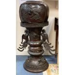 A bronze Chinese 17th Century urn, including stand, raised decorative birds,