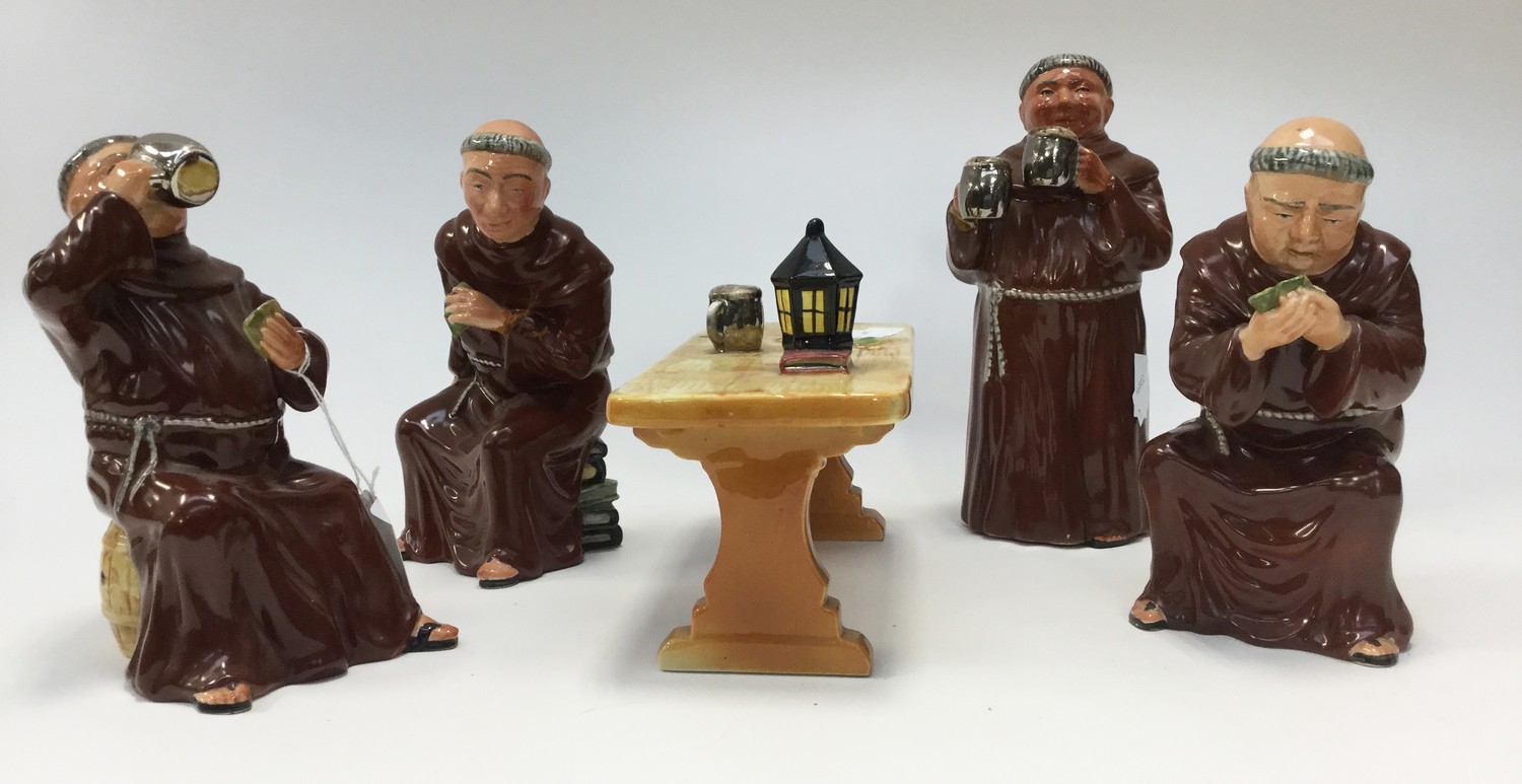 Bretby figurines of four monks drinking ale, one standing,