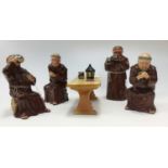 Bretby figurines of four monks drinking ale, one standing,