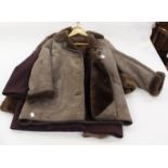 A 3/4 aubergine coloured cashmere coat with a amethyst coloured brooch with a pearl edging,