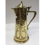 An Art Nouveau brass and pewter lined hot water jug, chased Art Nouveau decoration to body,