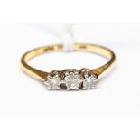 An 18ct gold and diamond three-stone ring, L, total gross weight 1.