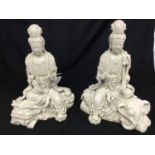 A pair of Chinese blanc de chine figures of Guanyin seated, one on a lion, the other on an elephant,