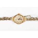 A ladies 9ct gold wristwatch, having plated strap, Arabic numerals, seconds hand,