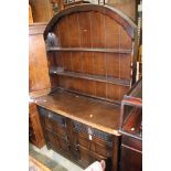 An oak dresser and rack, probably Ercol, the rack with fitted shelves,