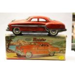 A boxed Minister Deluxe red saloon car,