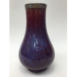 A Chinese flambe glazed vase, of true baluster form, spreading from the narrow galleried rim,