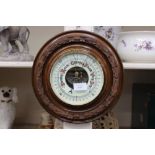 A barometer set into a circular wood mount (1)