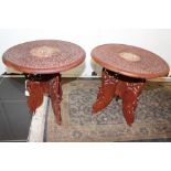 A pair of Anglo Indian carved top tables, each with bone inlaid tops and standing on folding bases,