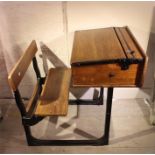 An early 20th century oak childs school desk with attached seat.