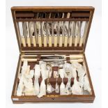 An early 20th Century oak canteen of cutlery, comprising six place settings,