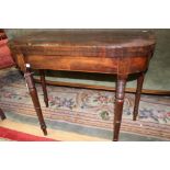 An early 19th Century mahogany fold-over card table, rosewood cross-banded edge, inlaid frieze,