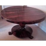 A William IV rosewood centre table, tilt top, the top raised on an octagonal baluster column,