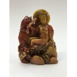 A Chinese carved soapstone Guanyin, 20th century, brown and olive hues, approx 10.