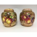 A pair of Royal Worcester ginger jars and covers, fruit painted, one signed Freeman, one signed N.