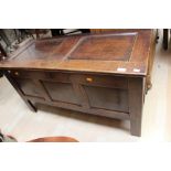 An early 18th Century oak joined chest, two panelled top, three panelled front,