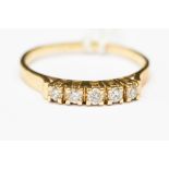 A 14ct gold and diamond dress ring, set with five diamonds set claw mounts, each approx 0.