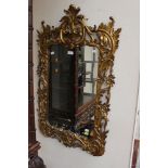 A giltwood framed wall mirror, in the Rococo style,