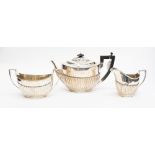 A Victorian silver three piece tea set, the teapot and sugar by Walter & John Barnard, London 1889,