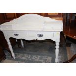 A French cream painted writing desk, fitted with two drawers and a letter rack to top,