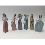 A Lladro collection of figures, comprising ladies with hats,