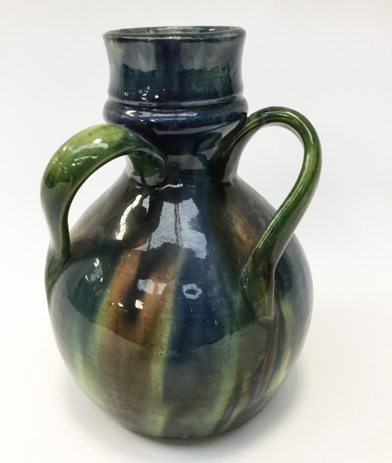 A Belgian Art Pottery tyg vase, green glazed bottle form with three handles,