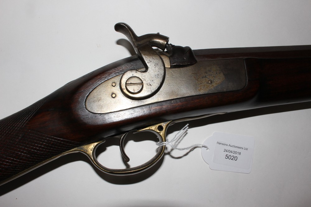 A Percussion cap rifle. Working action. 49 inch long barrel. Brass trigger guard. No makers marks.