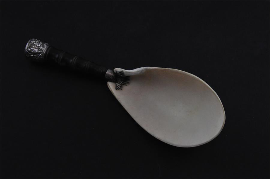 A large Burmese white metal mounted spoon, late 19th/early 20th century, the bowl fashioned from